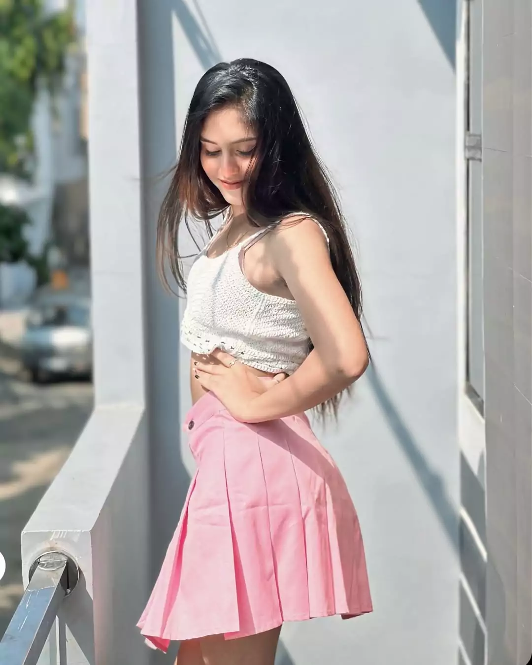 A young woman in a pink skirt and style in her fashionable outfit.