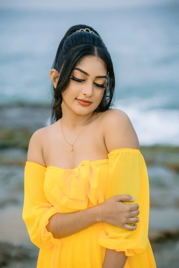 A beautiful young woman in a yellow dress, showcasing her beauty.