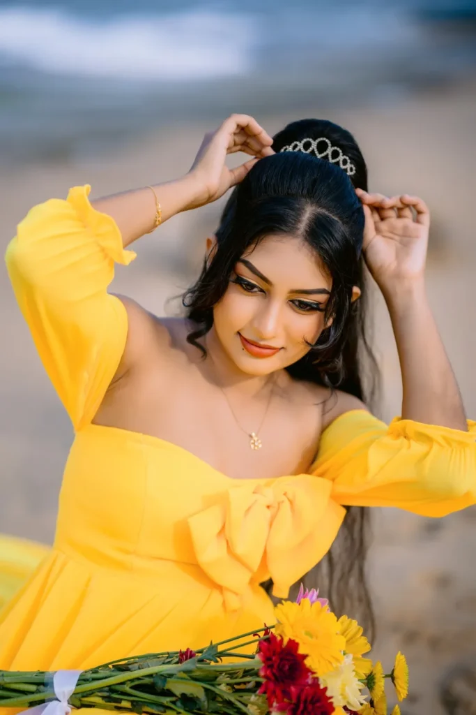 A beautiful young woman in a yellow dress, showcasing her beauty.