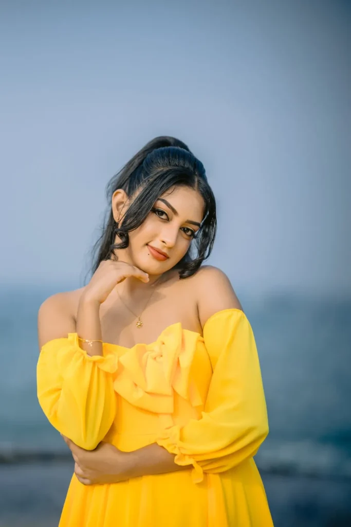 A beautiful young woman in a yellow dress, showcasing her beauty.