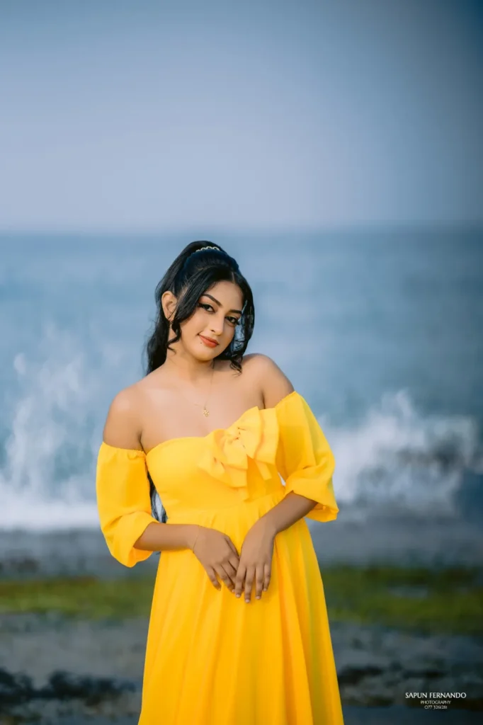 A beautiful young woman in a yellow dress, showcasing her beauty.