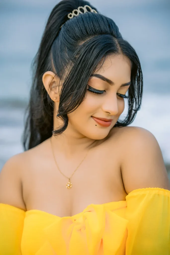 A beautiful young woman in a yellow dress, showcasing her beauty.