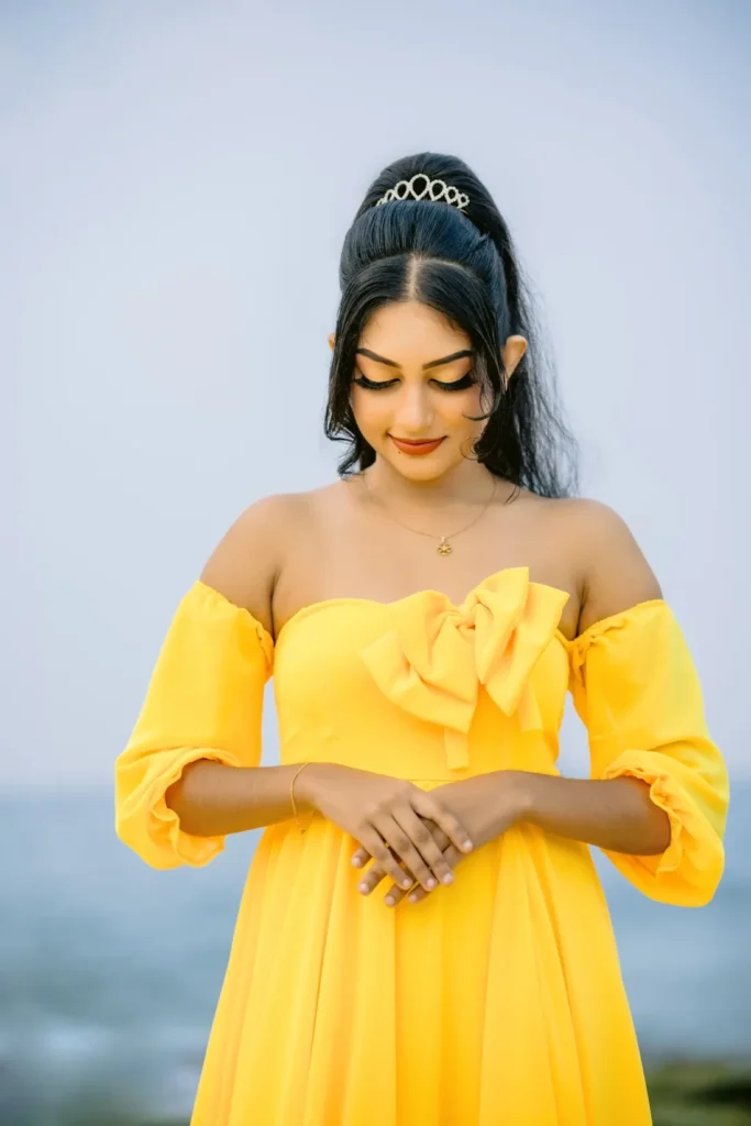 A beautiful young woman in a yellow dress, showcasing her beauty.