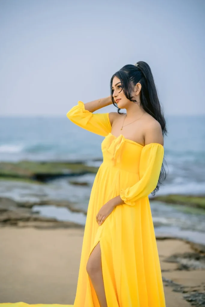 A beautiful young woman in a yellow dress, showcasing her beauty.