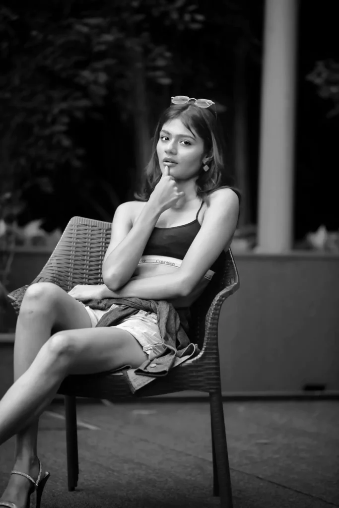 Thoughtful woman resting hand on chin in black and white ambiance