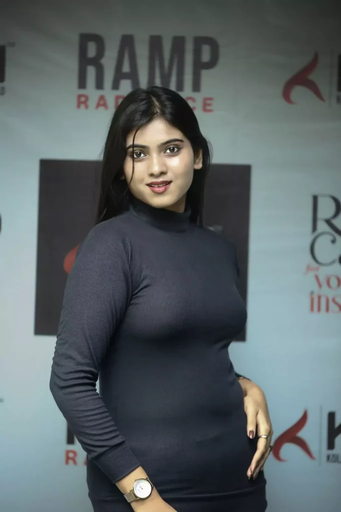 Front pose of Indian model in fitted black dress at fashion shoot