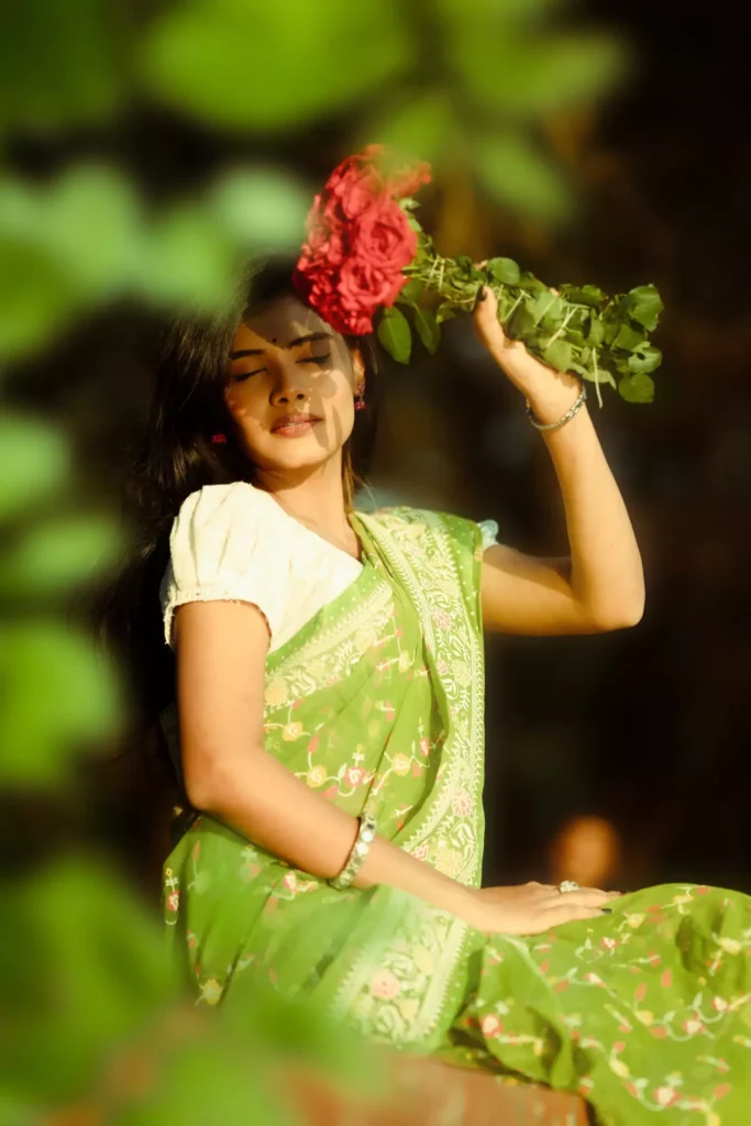 Woman lifting flower and smiling playfully.