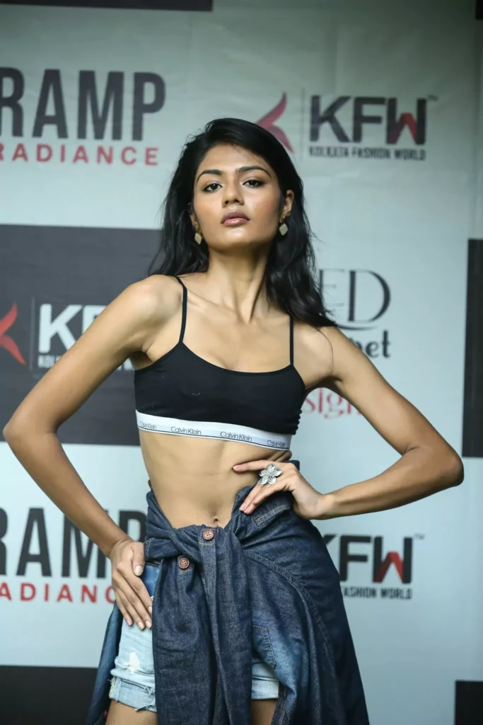 Female model showcasing edgy street style on the runway.