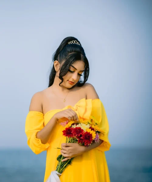 beautiful woman in a yellow dress (14) A beautiful young woman in a yellow dress holds a colourful bouquet of flowers, showcasing her beauty.